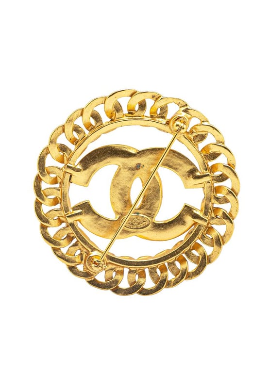 This brooch features a gold-tone metal body and a back pin closure.Brand: Chanel VintageCondition: PrelovedType: Costume BroochRating: ABMain Material: MetalDimensions (LxWxD): 5.5x5.5x0Comments: Exterior Back Discolored Scratched. Lock Scratched. Exterior Front Discolored Scratched.