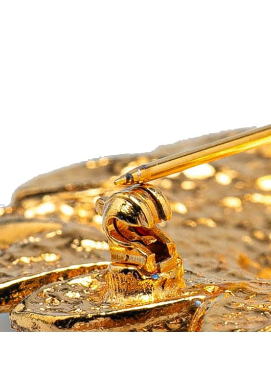 This brooch features a gold-plated metal body and back pin closure.Brand: Chanel VintageCondition: PrelovedType: Costume BroochRating: B+Main Material: MetalDimensions (LxWxD): 5.2x4.9x0Comments: Exterior Back Scratched. Lock Scratched. Exterior Front Scratched.