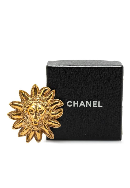 This brooch features a gold-plated metal body and back pin closure.Brand: Chanel VintageCondition: PrelovedType: Costume BroochRating: B+Main Material: MetalDimensions (LxWxD): 5.2x4.9x0Comments: Exterior Back Scratched. Lock Scratched. Exterior Front Scratched.
