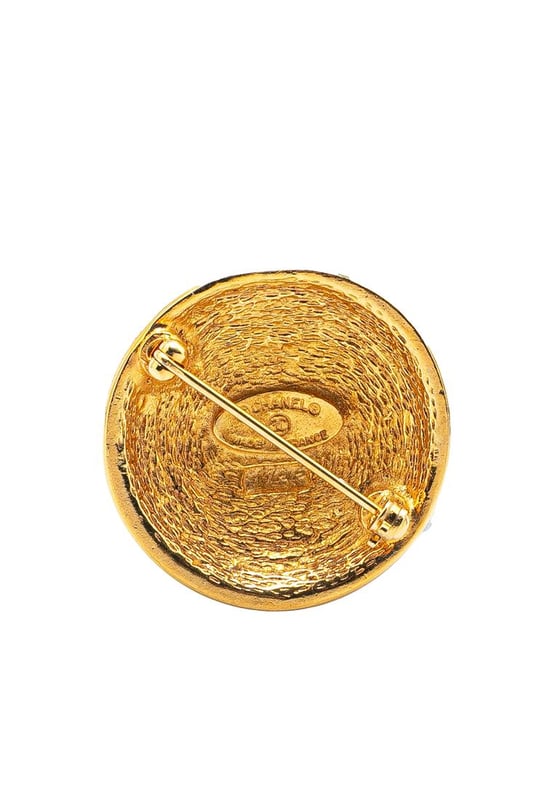 This brooch features a gold-tone metal body and a back pin closure.Brand: Chanel VintageCondition: PrelovedType: Costume BroochRating: B+Main Material: MetalDimensions (LxWxD): 3x3x0Comments: Exterior Back Scratched. Lock Scratched. Exterior Front Scratched.