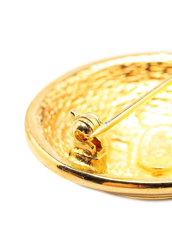 This brooch features a gold-tone metal body and a back pin closure.Brand: Chanel VintageCondition: PrelovedType: Costume BroochRating: B+Main Material: MetalDimensions (LxWxD): 3x3x0Comments: Exterior Back Scratched. Lock Scratched. Exterior Front Scratched.