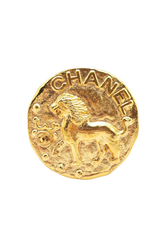 This brooch features a gold-plated metal body and a back pin closure.Brand: Chanel VintageCondition: PrelovedType: Costume BroochRating: B+Main Material: MetalDimensions (LxWxD): 5x5x0Comments: Exterior Back Scratched. Exterior Back stained with Other.