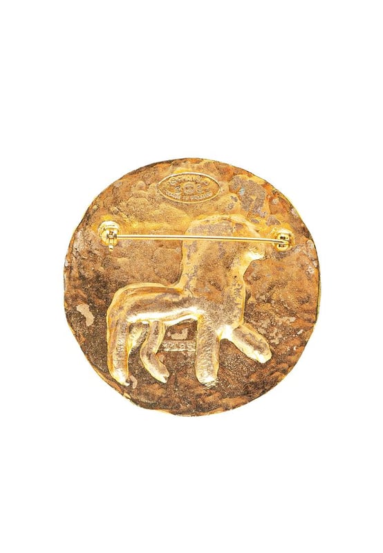 This brooch features a gold-plated metal body and a back pin closure.Brand: Chanel VintageCondition: PrelovedType: Costume BroochRating: B+Main Material: MetalDimensions (LxWxD): 5x5x0Comments: Exterior Back Scratched. Exterior Back stained with Other.