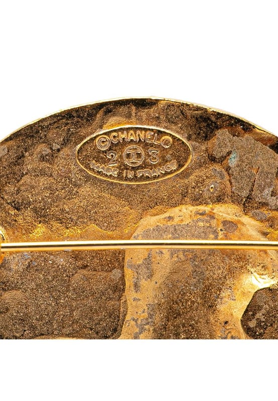 This brooch features a gold-plated metal body and a back pin closure.Brand: Chanel VintageCondition: PrelovedType: Costume BroochRating: B+Main Material: MetalDimensions (LxWxD): 5x5x0Comments: Exterior Back Scratched. Exterior Back stained with Other.