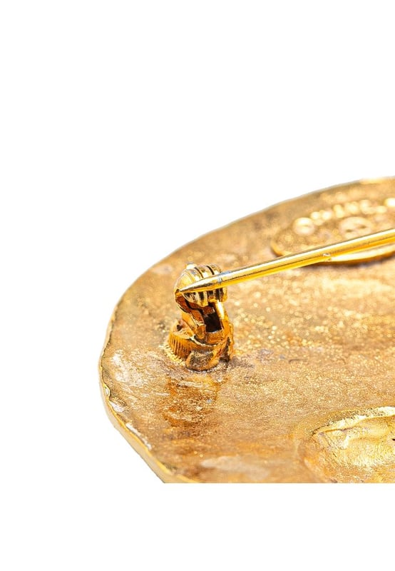 This brooch features a gold-plated metal body and a back pin closure.Brand: Chanel VintageCondition: PrelovedType: Costume BroochRating: B+Main Material: MetalDimensions (LxWxD): 5x5x0Comments: Exterior Back Scratched. Exterior Back stained with Other.