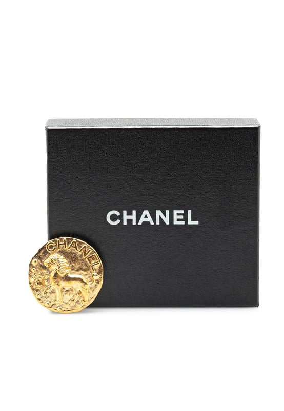 This brooch features a gold-plated metal body and a back pin closure.Brand: Chanel VintageCondition: PrelovedType: Costume BroochRating: B+Main Material: MetalDimensions (LxWxD): 5x5x0Comments: Exterior Back Scratched. Exterior Back stained with Other.
