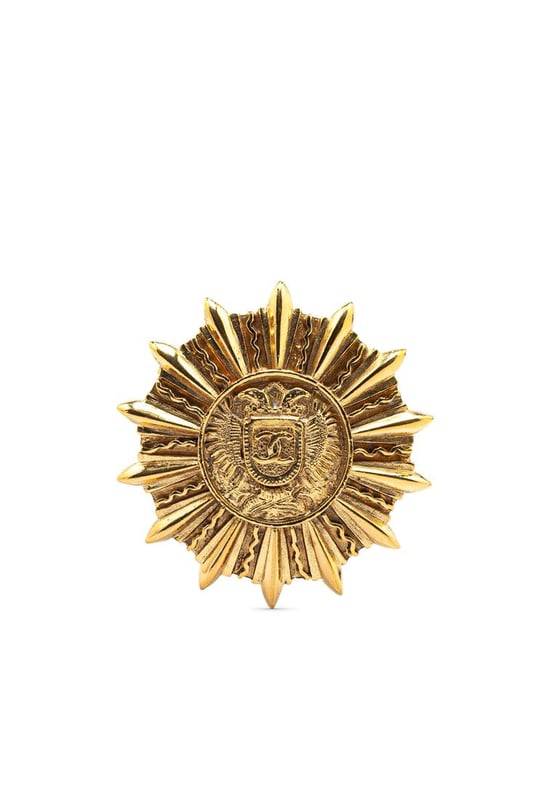 This brooch features a gold-plated metal body and back pin closure.Brand: Chanel VintageCondition: PrelovedType: Costume BroochRating: ABMain Material: MetalDimensions (LxWxD): 4.7x4.6x0Comments: Exterior Back Scratched. Exterior Back stained with Other. Lock Scratched. Exterior Front Scratched. Exterior Front stained with Other.