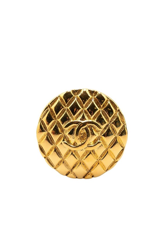 This brooch features a gold-plated metal body and a back pin closure.Brand: Chanel VintageCondition: PrelovedType: Costume BroochRating: B+Main Material: MetalDimensions (LxWxD): 4x4x0Comments: Exterior Back Scratched. Lock Rusty/Tarnished Scratched. Exterior Front Scratched.