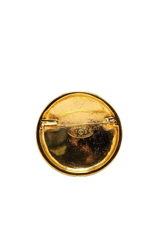 This brooch features a gold-plated metal body and a back pin closure.Brand: Chanel VintageCondition: PrelovedType: Costume BroochRating: B+Main Material: MetalDimensions (LxWxD): 4x4x0Comments: Exterior Back Scratched. Lock Rusty/Tarnished Scratched. Exterior Front Scratched.