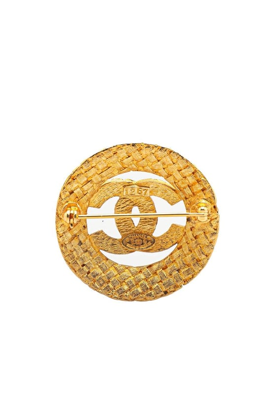 This brooch features a gold-tone metal body and a back pin closure.Brand: Chanel VintageCondition: PrelovedType: Costume BroochRating: B+Main Material: MetalDimensions (LxWxD): 3.6x3.6x0Comments: Exterior Back Discolored Scratched. Lock Scratched.