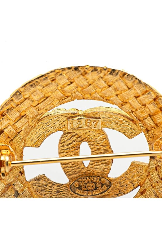 This brooch features a gold-tone metal body and a back pin closure.Brand: Chanel VintageCondition: PrelovedType: Costume BroochRating: B+Main Material: MetalDimensions (LxWxD): 3.6x3.6x0Comments: Exterior Back Discolored Scratched. Lock Scratched.
