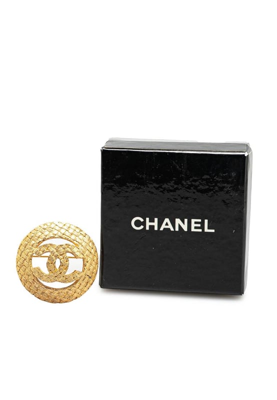 This brooch features a gold-tone metal body and a back pin closure.Brand: Chanel VintageCondition: PrelovedType: Costume BroochRating: B+Main Material: MetalDimensions (LxWxD): 3.6x3.6x0Comments: Exterior Back Discolored Scratched. Lock Scratched.