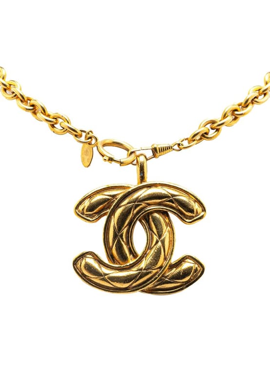 This necklace features a gold-tone chain a gold-tone quilted CC pendant and a spring ring closure.Brand: Chanel VintageCondition: PrelovedType: Costume NecklaceRating: B+Main Material: MetalDimensions (LxWxD): 84.3x4.2x0Comments: Exterior Back Scratched. Lock Scratched. Exterior Front Scratched. Exterior Front stained with Other. Exterior Handle Scratched.