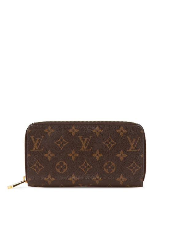 This wallet features a monogram canvas body a zip-around closure and interior zip and slip pockets.Brand: Louis Vuitton VintageCondition: PrelovedType: Long WalletsRating: B+Main Material: CanvasDimensions (LxWxD): 10x19x2.5Comments: Exterior Bottom Worn. Exterior Corners Worn. Interior Pocket stained with Other. Interior Lining Worn. Exterior Side Worn. Exterior Top Worn. Zipper Rusty/Tarnished Scratched.