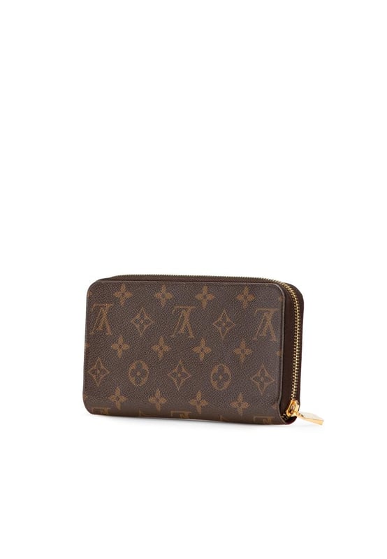 This wallet features a monogram canvas body a zip-around closure and interior zip and slip pockets.Brand: Louis Vuitton VintageCondition: PrelovedType: Long WalletsRating: B+Main Material: CanvasDimensions (LxWxD): 10x19x2.5Comments: Exterior Bottom Worn. Exterior Corners Worn. Interior Pocket stained with Other. Interior Lining Worn. Exterior Side Worn. Exterior Top Worn. Zipper Rusty/Tarnished Scratched.