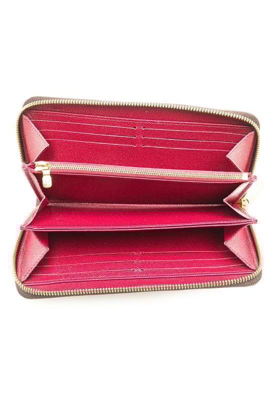 This wallet features a monogram canvas body a zip-around closure and interior zip and slip pockets.Brand: Louis Vuitton VintageCondition: PrelovedType: Long WalletsRating: B+Main Material: CanvasDimensions (LxWxD): 10x19x2.5Comments: Exterior Bottom Worn. Exterior Corners Worn. Interior Pocket stained with Other. Interior Lining Worn. Exterior Side Worn. Exterior Top Worn. Zipper Rusty/Tarnished Scratched.