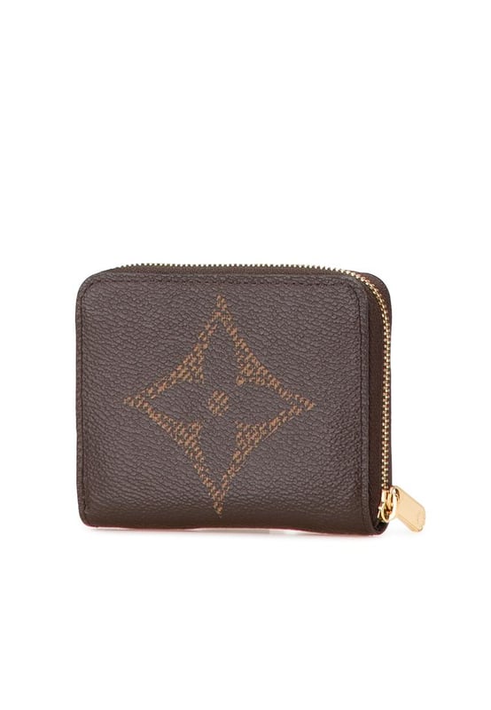 This coin purse features a monogram giant canvas body a zip-around closure and interior slip compartments.Brand: Louis Vuitton VintageCondition: PrelovedType: Coin PouchRating: ABMain Material: CanvasDimensions (LxWxD): 8.5x11x2Dust Bag: YesComments: Exterior Corners Worn. Interior Lining Worn. Interior Lining stained with Other. Exterior Top Worn. Zipper Scratched.