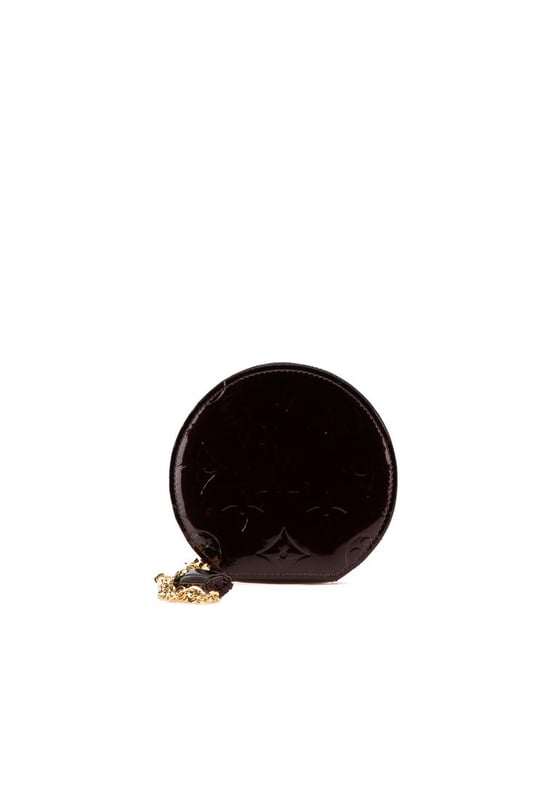 This coin pouch features a monogram vernis leather body a key chain attachment and a zip around closure.Brand: Louis Vuitton VintageCondition: PrelovedType: Coin PouchRating: B+Main Material: LeatherDimensions (LxWxD): 10x10.5x1.5Dust Bag: YesComments: Exterior Back Scratched. Exterior Back stained with Other. Exterior Bottom stained with Other. Embellishment Scratched. Exterior Front stained with Other. Interior Lining Scratched. Interior Lining stained with Other. Zipper Rusty/Tarnished Scratched.