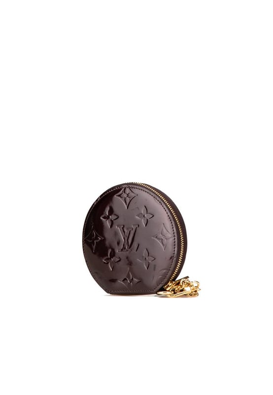 This coin pouch features a monogram vernis leather body a key chain attachment and a zip around closure.Brand: Louis Vuitton VintageCondition: PrelovedType: Coin PouchRating: B+Main Material: LeatherDimensions (LxWxD): 10x10.5x1.5Dust Bag: YesComments: Exterior Back Scratched. Exterior Back stained with Other. Exterior Bottom stained with Other. Embellishment Scratched. Exterior Front stained with Other. Interior Lining Scratched. Interior Lining stained with Other. Zipper Rusty/Tarnished Scratched.