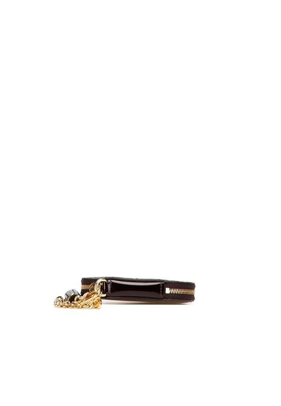 This coin pouch features a monogram vernis leather body a key chain attachment and a zip around closure.Brand: Louis Vuitton VintageCondition: PrelovedType: Coin PouchRating: B+Main Material: LeatherDimensions (LxWxD): 10x10.5x1.5Dust Bag: YesComments: Exterior Back Scratched. Exterior Back stained with Other. Exterior Bottom stained with Other. Embellishment Scratched. Exterior Front stained with Other. Interior Lining Scratched. Interior Lining stained with Other. Zipper Rusty/Tarnished Scratched.