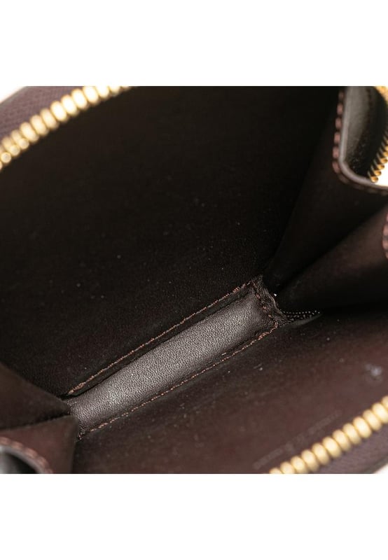 This coin pouch features a monogram vernis leather body a key chain attachment and a zip around closure.Brand: Louis Vuitton VintageCondition: PrelovedType: Coin PouchRating: B+Main Material: LeatherDimensions (LxWxD): 10x10.5x1.5Dust Bag: YesComments: Exterior Back Scratched. Exterior Back stained with Other. Exterior Bottom stained with Other. Embellishment Scratched. Exterior Front stained with Other. Interior Lining Scratched. Interior Lining stained with Other. Zipper Rusty/Tarnished Scratched.