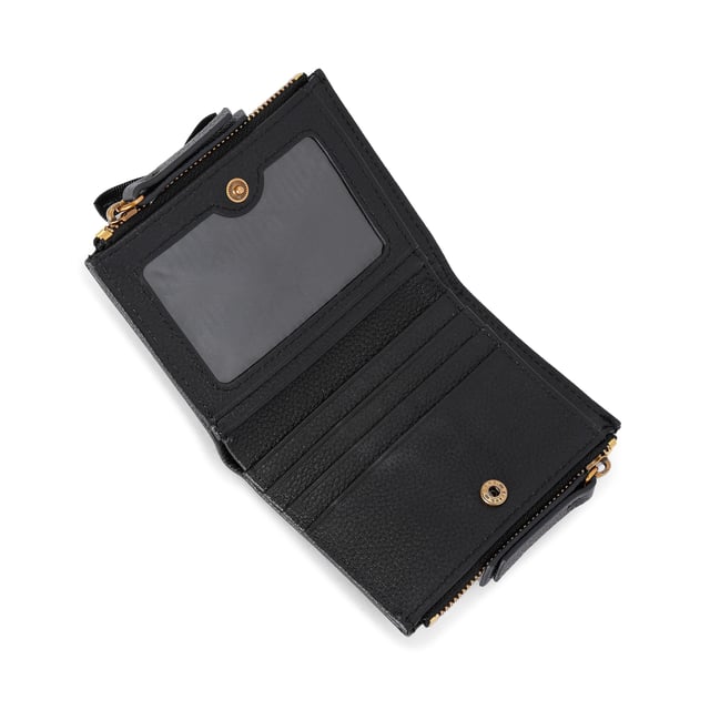 The Greenwich Mini Purse features a black grained leather exterior. There is an antiqued brass eagle head and branding on the front. 9cm (H), 11cm (L), 2cm (D).