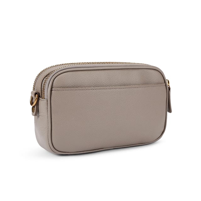 This Kurt Geiger 2Zip Greenwich Cross Body bag is crafted in a taupe grained leather. There is a flat pocket on the back and a magnetic snap closure pocket on the front. There is antiqued brass branding on the front flap. Dimensions: 14cm (H), 23cm (L), 7cm(D). Strap length: 132cm.