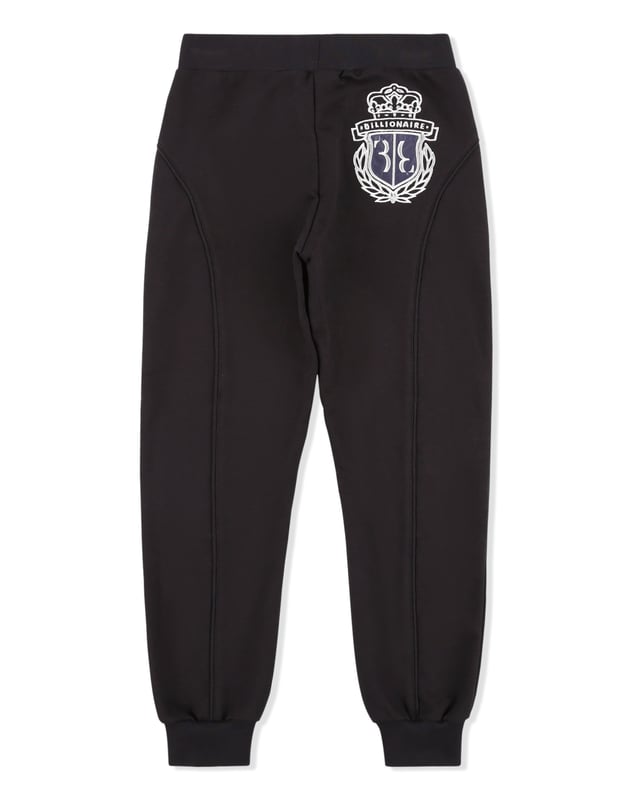 The coat of arms is common trait of a special family. On these cotton jogging pants it is embroidered on the patch sewn on the back. Piping on the stitching and patches on knees give the item a sportier look. Two slit pockets. Ribbed bottom cuffs and waistband.