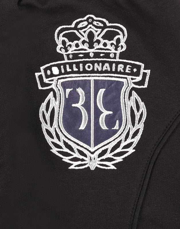 The coat of arms is common trait of a special family. On these cotton jogging pants it is embroidered on the patch sewn on the back. Piping on the stitching and patches on knees give the item a sportier look. Two slit pockets. Ribbed bottom cuffs and waistband.