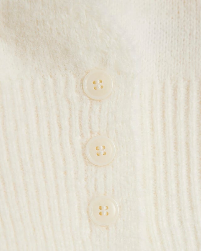 Crew neck, Cut out detail, Button fastening, Long sleeved