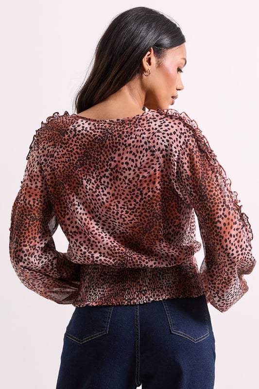Elegant wrap detail neckline for a flattering silhouette
        Voluminous long sleeves with gentle gathering for a feminine touch
        Shirred elasticated hem creating a stylish cropped profile
        All-over animal print pattern adding contemporary flair
        Lightweight woven fabric offering comfortable wear throughout the day
    
    This Dorothy Perkins Animal Wrap Detail Shirred Hem Top combines sophistication with on-trend styling. The wrap neckline creates a flattering V-shape that frames your dcolletage beautifully without revealing too much, whilst the shirred elasticated hem defines your waist for a figure-enhancing effect. Style with your favourite high-waisted jeans and ankle boots for weekend brunches with the girls, or pair with tailored trousers and ballet flats for family gatherings. The versatile design transitions effortlessly from daytime casual to evening drinks, making it a wardrobe essential for the modern woman who values both style and comfort. Layer with a cardigan and add simple jewellery for a polished finish that works wonderfully for baby showers or informal office settings. This top offers the perfect balance of current fashion trends with timeless wearability.