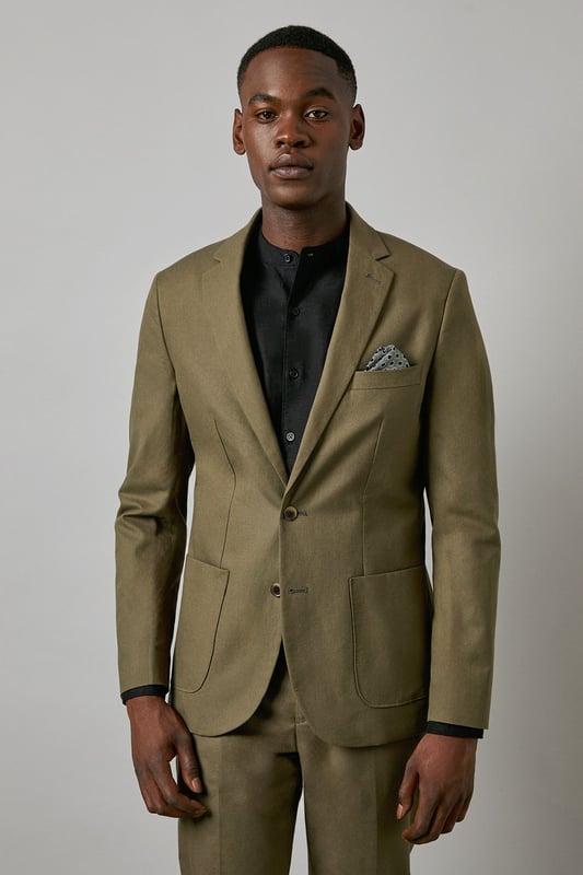 Crafted from a cotton-linen blend fabric for breathable comfort and a refined texture
        Slim fit design offers a contemporary silhouette that defines the shoulders and chest
        Two-button fastening with notched lapels for classic tailoring appeal
        Patch pockets add a relaxed touch to this smart jacket
        Versatile piece that transitions seamlessly from office to social occasions
    
    This Burton suit jacket combines timeless style with modern tailoring for the discerning gentleman. The cotton-linen blend creates a lightweight feel with natural texture, perfect for year-round wear. The slim fit construction shapes a sharp silhouette without sacrificing comfort, tapering through the waist for a defined look that sits close to the body. Style as seen with a black shirt for a contemporary twist on formal attire, or pair with a crisp white shirt and patterned pocket square for traditional occasions. The jacket works brilliantly for summer weddings, garden parties or smart office environments. For casual sophistication, team with dark denim jeans and Chelsea boots. Dry clean only to maintain the jacket's clean lines and structured appearance.