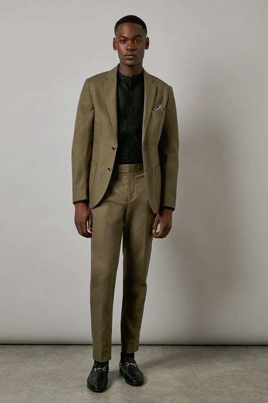 Crafted from a cotton-linen blend fabric for breathable comfort and a refined texture
        Slim fit design offers a contemporary silhouette that defines the shoulders and chest
        Two-button fastening with notched lapels for classic tailoring appeal
        Patch pockets add a relaxed touch to this smart jacket
        Versatile piece that transitions seamlessly from office to social occasions
    
    This Burton suit jacket combines timeless style with modern tailoring for the discerning gentleman. The cotton-linen blend creates a lightweight feel with natural texture, perfect for year-round wear. The slim fit construction shapes a sharp silhouette without sacrificing comfort, tapering through the waist for a defined look that sits close to the body. Style as seen with a black shirt for a contemporary twist on formal attire, or pair with a crisp white shirt and patterned pocket square for traditional occasions. The jacket works brilliantly for summer weddings, garden parties or smart office environments. For casual sophistication, team with dark denim jeans and Chelsea boots. Dry clean only to maintain the jacket's clean lines and structured appearance.