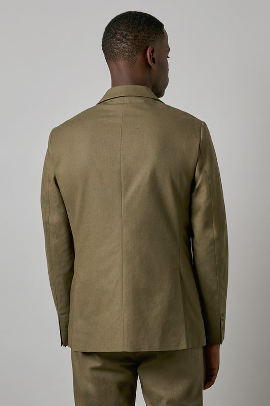 Crafted from a cotton-linen blend fabric for breathable comfort and a refined texture
        Slim fit design offers a contemporary silhouette that defines the shoulders and chest
        Two-button fastening with notched lapels for classic tailoring appeal
        Patch pockets add a relaxed touch to this smart jacket
        Versatile piece that transitions seamlessly from office to social occasions
    
    This Burton suit jacket combines timeless style with modern tailoring for the discerning gentleman. The cotton-linen blend creates a lightweight feel with natural texture, perfect for year-round wear. The slim fit construction shapes a sharp silhouette without sacrificing comfort, tapering through the waist for a defined look that sits close to the body. Style as seen with a black shirt for a contemporary twist on formal attire, or pair with a crisp white shirt and patterned pocket square for traditional occasions. The jacket works brilliantly for summer weddings, garden parties or smart office environments. For casual sophistication, team with dark denim jeans and Chelsea boots. Dry clean only to maintain the jacket's clean lines and structured appearance.