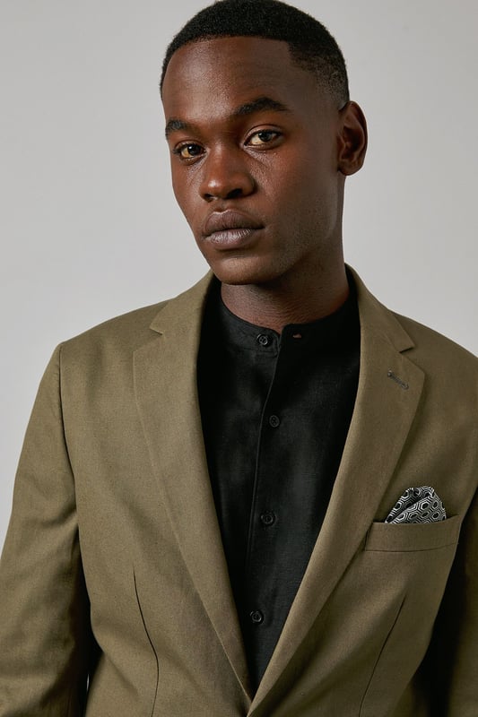 Crafted from a cotton-linen blend fabric for breathable comfort and a refined texture
        Slim fit design offers a contemporary silhouette that defines the shoulders and chest
        Two-button fastening with notched lapels for classic tailoring appeal
        Patch pockets add a relaxed touch to this smart jacket
        Versatile piece that transitions seamlessly from office to social occasions
    
    This Burton suit jacket combines timeless style with modern tailoring for the discerning gentleman. The cotton-linen blend creates a lightweight feel with natural texture, perfect for year-round wear. The slim fit construction shapes a sharp silhouette without sacrificing comfort, tapering through the waist for a defined look that sits close to the body. Style as seen with a black shirt for a contemporary twist on formal attire, or pair with a crisp white shirt and patterned pocket square for traditional occasions. The jacket works brilliantly for summer weddings, garden parties or smart office environments. For casual sophistication, team with dark denim jeans and Chelsea boots. Dry clean only to maintain the jacket's clean lines and structured appearance.