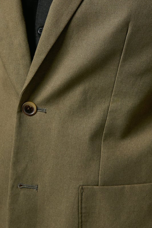Crafted from a cotton-linen blend fabric for breathable comfort and a refined texture
        Slim fit design offers a contemporary silhouette that defines the shoulders and chest
        Two-button fastening with notched lapels for classic tailoring appeal
        Patch pockets add a relaxed touch to this smart jacket
        Versatile piece that transitions seamlessly from office to social occasions
    
    This Burton suit jacket combines timeless style with modern tailoring for the discerning gentleman. The cotton-linen blend creates a lightweight feel with natural texture, perfect for year-round wear. The slim fit construction shapes a sharp silhouette without sacrificing comfort, tapering through the waist for a defined look that sits close to the body. Style as seen with a black shirt for a contemporary twist on formal attire, or pair with a crisp white shirt and patterned pocket square for traditional occasions. The jacket works brilliantly for summer weddings, garden parties or smart office environments. For casual sophistication, team with dark denim jeans and Chelsea boots. Dry clean only to maintain the jacket's clean lines and structured appearance.
