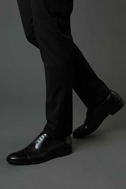 Classic Oxford design with traditional toe cap detailing
        High shine genuine leather upper for a sophisticated finish
        Traditional lace-up fastening with five eyelets for secure fit
        Sleek silhouette with minimal stitching for a clean, refined look
        Versatile design suitable for both formal occasions and smart-casual settings
    
    These timeless Oxford shoes from Burton combine classic British styling with everyday versatility. The high shine leather construction creates a polished appearance that works effortlessly with formal attire, while remaining understated enough for more relaxed occasions. Pair with tailored trousers as shown for business meetings or important events, or style with dark denim for smart pub lunches with mates. The traditional toe cap and clean lines reflect a heritage-inspired aesthetic that never goes out of fashion. Comfortable enough for all-day wear at the office, yet smart enough for special occasions, these Oxfords represent the perfect balance of practicality and style. Their durable construction ensures they'll remain a wardrobe staple for years to come - simply buff regularly to maintain their distinguished shine.