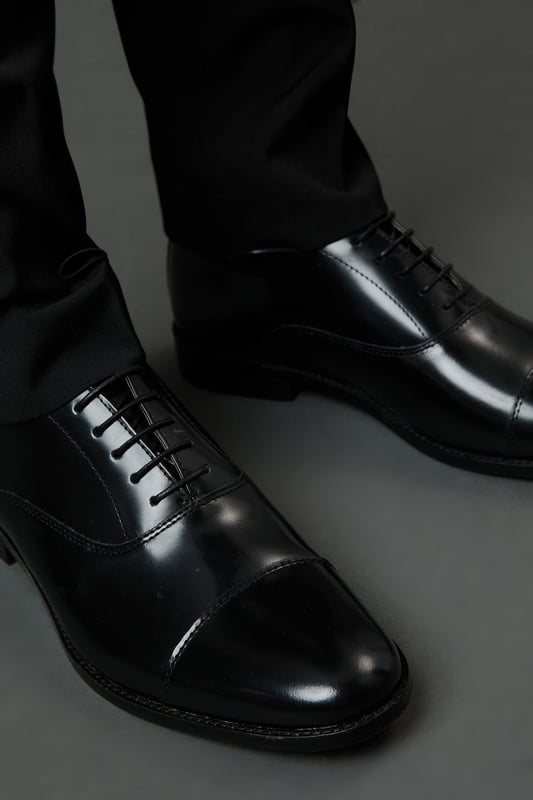 Classic Oxford design with traditional toe cap detailing
        High shine genuine leather upper for a sophisticated finish
        Traditional lace-up fastening with five eyelets for secure fit
        Sleek silhouette with minimal stitching for a clean, refined look
        Versatile design suitable for both formal occasions and smart-casual settings
    
    These timeless Oxford shoes from Burton combine classic British styling with everyday versatility. The high shine leather construction creates a polished appearance that works effortlessly with formal attire, while remaining understated enough for more relaxed occasions. Pair with tailored trousers as shown for business meetings or important events, or style with dark denim for smart pub lunches with mates. The traditional toe cap and clean lines reflect a heritage-inspired aesthetic that never goes out of fashion. Comfortable enough for all-day wear at the office, yet smart enough for special occasions, these Oxfords represent the perfect balance of practicality and style. Their durable construction ensures they'll remain a wardrobe staple for years to come - simply buff regularly to maintain their distinguished shine.