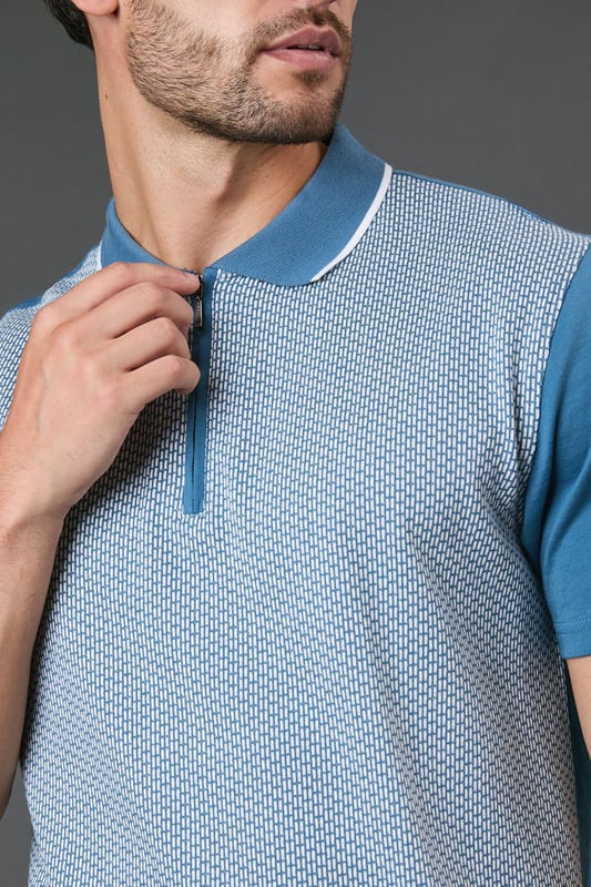 Distinctive jacquard pattern across the front body for a textured appearance
        Quarter-zip neckline with contrast tipping for a sporty finish
        Contrast solid sleeves creating a modern colour-block effect
        Ribbed collar with contrast trim for a refined touch
        Comfortable cotton fabric ideal for all-day wear
    
    This Burton jacquard polo offers a contemporary twist on a classic style. The textured pattern across the front creates visual interest whilst maintaining a sophisticated look that works perfectly for various casual occasions. Style it as shown with dark trousers and white trainers for an effortlessly smart weekend outfit, or pair with your favourite jeans for a relaxed pub lunch with mates. The quarter-zip detail adds functionality and a sporty element that nods to active lifestyles without compromising on style. Perfect for summer barbecues, casual Fridays at the office, or watching the match with friends. The contrast sleeves and collar detailing provide just enough interest to stand out from standard polos in your wardrobe, whilst the cotton construction ensures breathability and comfort throughout the day. A versatile addition to any casual wardrobe that bridges the gap between laid-back and put-together.