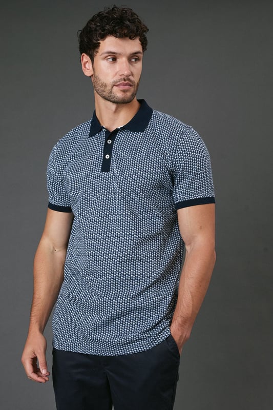 Distinctive abstract geometric pattern throughout for a modern twist on classic polo styling
        Contrast collar and sleeve cuffs add refined detailing to the design
        Three-button placket for adjustable neckline comfort
        Soft cotton fabric ensures breathability and all-day comfort
        Regular fit silhouette offers ease of movement without sacrificing style
    
    This Burton abstract geo polo shirt combines timeless appeal with contemporary pattern work, making it a versatile addition to your casual wardrobe. The contrast collar and cuffs create a smart finish that works brilliantly when paired with dark trousers as shown, or with your favourite chinos for weekend outings. Perfect for casual gatherings at the pub with mates or family barbecues, this polo offers that sweet spot between relaxed and put-together. For a complete look, team with dark jeans or chinos and clean white trainers - ideal for those occasions when you want to look effortlessly stylish without appearing overdressed. The breathable cotton construction ensures comfort throughout the day, whether you're watching the match or enjoying a casual lunch out. Machine washable at 30 degrees, this polo maintains its shape and pattern with proper care.