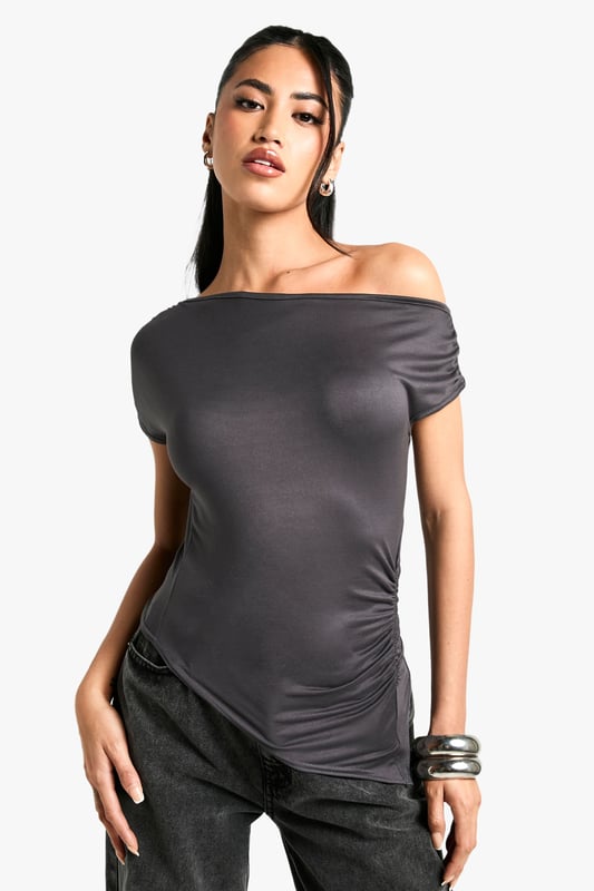 Off-shoulder design for a chic, contemporary look
        Soft, figure-hugging fabric that drapes beautifully
        Ruched detailing adds texture and interest
        Short sleeves for versatile wear
        Asymmetrical neckline creates a unique silhouette
    
    This super-soft off-shoulder top from Boohoo is the epitome of effortless style. The ruched detailing and figure-hugging fit create a flattering silhouette that's perfect for a variety of occasions. Pair it with wide-leg trousers and statement jewellery for a trendy daytime look, or dress it up with a sleek midi skirt and heels for evening drinks. The versatile design allows for easy transition from casual brunches to more upscale events. The asymmetrical neckline adds a touch of drama, making this top a standout piece in any wardrobe. Ideal for the fashion-forward woman who values both comfort and style, this top is a must-have for those who want to stay on-trend without compromising on wearability.
