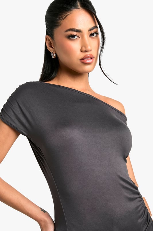 Off-shoulder design for a chic, contemporary look
        Soft, figure-hugging fabric that drapes beautifully
        Ruched detailing adds texture and interest
        Short sleeves for versatile wear
        Asymmetrical neckline creates a unique silhouette
    
    This super-soft off-shoulder top from Boohoo is the epitome of effortless style. The ruched detailing and figure-hugging fit create a flattering silhouette that's perfect for a variety of occasions. Pair it with wide-leg trousers and statement jewellery for a trendy daytime look, or dress it up with a sleek midi skirt and heels for evening drinks. The versatile design allows for easy transition from casual brunches to more upscale events. The asymmetrical neckline adds a touch of drama, making this top a standout piece in any wardrobe. Ideal for the fashion-forward woman who values both comfort and style, this top is a must-have for those who want to stay on-trend without compromising on wearability.