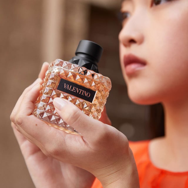 Experience the enchanting allure of Valentino Donna Born In Roma Coral Fantasy Eau de Parfum. This exquisite fragrance captures the essence of a Roman sunset with vibrant notes. The top note features a refreshing kiwi accord blended with sparkling orange for a bold introduction. At its heart, a luxurious infusion of jasmine flowers creates a modern floral bouquet. Finally, the warm base note of ambrette seeds adds a soft, textured finish. Housed in a stunning coral bottle inspired by Rome's twilight, this 50ml perfume is a must-have for every woman.