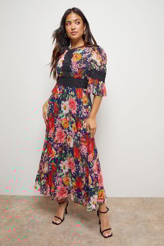Elegant midi dress featuring delicate lace trim detailing across the bodice
        Feminine pleated skirt creates beautiful movement and dimension
        Flattering crew neckline complemented by charming three-quarter length sleeves
        Designed specifically for petite frames with a perfectly proportioned midi length
        Striking printed pattern throughout adds visual interest and contemporary appeal
    
    This enchanting Oasis midi dress combines classic femininity with modern design elements. The intricate lace trim adds a touch of romance to the bodice, whilst the pleated skirt creates a graceful silhouette that moves beautifully with every step. Perfect for special occasions, this dress can be styled with strappy heels and a clutch bag for weddings or formal events. The versatile design also transitions wonderfully to garden parties or race day events when paired with a fascinator and elegant jewellery. The three-quarter length sleeves offer just the right amount of coverage, making this piece suitable for various seasons. For cooler evenings, layer with a tailored blazer or delicate wrap to maintain the dress's refined aesthetic whilst staying comfortable throughout your event.