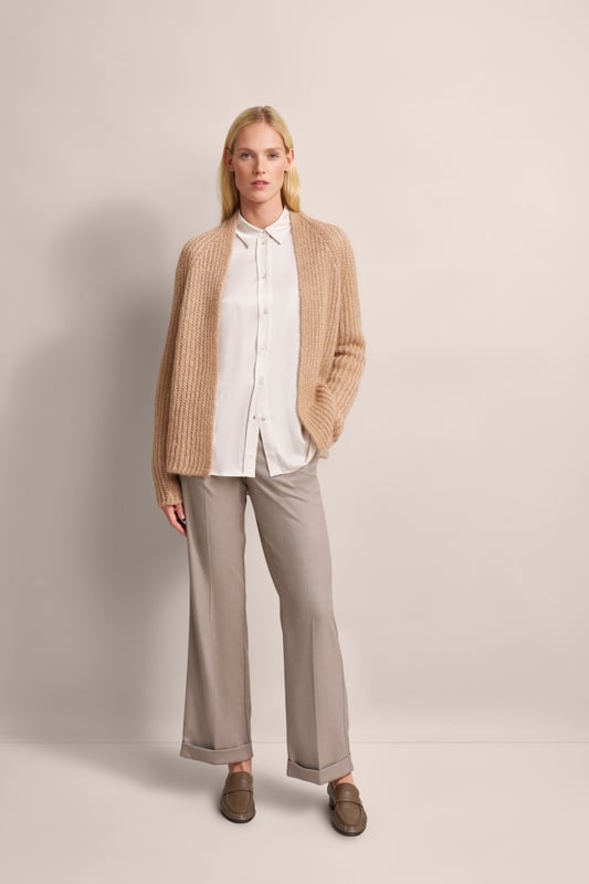 Hülle dich in den lässigen Charme des Two-tone-Cardigans von bugatti. Dieser offene Cardigan aus einer luxuriösen Alpaka-Wollmischung besticht durch sein einzigartiges Patentstrickmuster und seine gemütlichen Raglanärmel. Der schmeichelnde Schalkragen rundet das entspannte Design ab. Ein stilvoller Begleiter für kühle Tage!