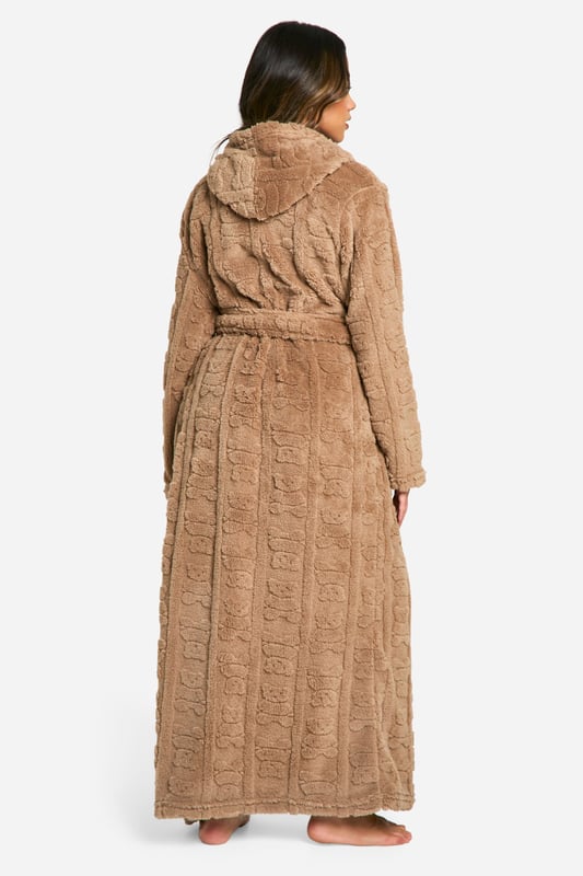 Bear Embossed Fleece Maxi Dressing Gown Luxuriously soft fleece fabric with embossed bear print
Full-length design for maximum coverage and warmth
Cosy hood for added comfort
Practical side pockets for convenience
Adjustable belt to cinch in the waist
Wrap yourself in ultimate comfort with this charming embossed bear print dressing gown. Perfect for those lazy mornings or cosy nights in, this full-length robe offers both style and functionality. The soft fleece fabric envelops you in warmth, while the hood provides an extra layer of snugness. Side pockets offer practicality for keeping your hands warm or storing small essentials. The adjustable belt allows you to customise the fit to your liking, creating a flattering silhouette. Whether you're enjoying a cup of tea on the sofa or preparing for a relaxing night's sleep, this dressing gown is your go-to for luxurious loungewear. Pair with your favourite pyjamas or nightdress for a complete bedtime ensemble that's both fashionable and comfortable.