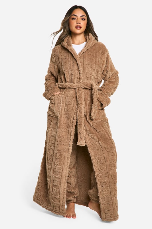Bear Embossed Fleece Maxi Dressing Gown Luxuriously soft fleece fabric with embossed bear print
Full-length design for maximum coverage and warmth
Cosy hood for added comfort
Practical side pockets for convenience
Adjustable belt to cinch in the waist
Wrap yourself in ultimate comfort with this charming embossed bear print dressing gown. Perfect for those lazy mornings or cosy nights in, this full-length robe offers both style and functionality. The soft fleece fabric envelops you in warmth, while the hood provides an extra layer of snugness. Side pockets offer practicality for keeping your hands warm or storing small essentials. The adjustable belt allows you to customise the fit to your liking, creating a flattering silhouette. Whether you're enjoying a cup of tea on the sofa or preparing for a relaxing night's sleep, this dressing gown is your go-to for luxurious loungewear. Pair with your favourite pyjamas or nightdress for a complete bedtime ensemble that's both fashionable and comfortable.
