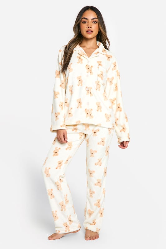 Loungewear Bear Print Fleece Button Front Shirt & Trousers Pyjama Set Adorable bear print fleece pyjama set
Cosy button-up top with notched collar
Relaxed fit trousers with elasticated waistband
Long sleeves for extra warmth
Soft and comfortable fleece fabric
Embrace ultimate comfort with this charming bear fleece pyjama set from Boohoo. Perfect for those chilly nights in, this set combines style and cosiness effortlessly. The button-up top features a classic notched collar and long sleeves, ideal for snuggling up on the sofa. Pair with fluffy slippers and your favourite hot beverage for the ultimate night in. Whether you're having a lazy Sunday morning or a girls' sleepover, this pyjama set is versatile enough for all your loungewear needs. The relaxed fit trousers with an elasticated waistband ensure unrestricted movement, making them perfect for lounging or sleeping. This set is a must-have addition to your loungewear collection, offering both comfort and a touch of whimsy to your relaxation time.