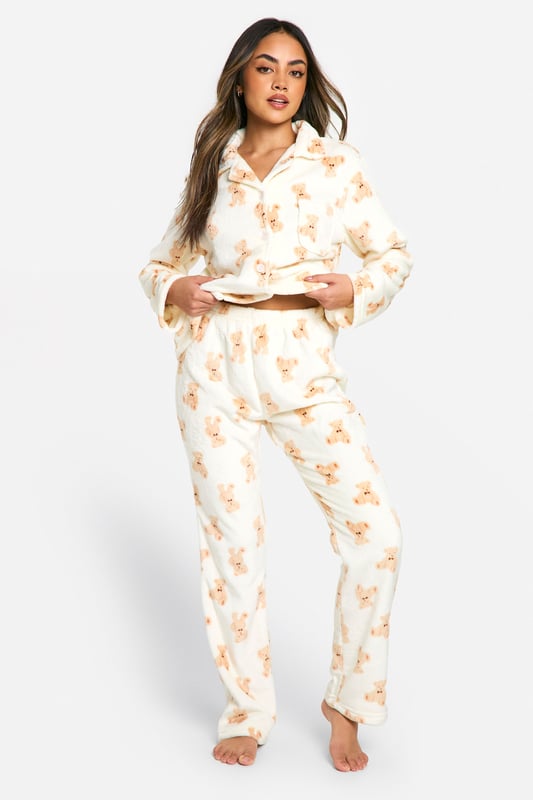 Loungewear Bear Print Fleece Button Front Shirt & Trousers Pyjama Set Adorable bear print fleece pyjama set
Cosy button-up top with notched collar
Relaxed fit trousers with elasticated waistband
Long sleeves for extra warmth
Soft and comfortable fleece fabric
Embrace ultimate comfort with this charming bear fleece pyjama set from Boohoo. Perfect for those chilly nights in, this set combines style and cosiness effortlessly. The button-up top features a classic notched collar and long sleeves, ideal for snuggling up on the sofa. Pair with fluffy slippers and your favourite hot beverage for the ultimate night in. Whether you're having a lazy Sunday morning or a girls' sleepover, this pyjama set is versatile enough for all your loungewear needs. The relaxed fit trousers with an elasticated waistband ensure unrestricted movement, making them perfect for lounging or sleeping. This set is a must-have addition to your loungewear collection, offering both comfort and a touch of whimsy to your relaxation time.