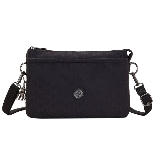 The Kipling Riri Signature Women's Black Crossbody Bag is a stylish and practical accessory, perfect for women who want a versatile bag that offers both style and functionality. With its sleek black design and signature Kipling details, this bag is ideal for daily use or casual outings.
Key features:
Classic Crossbody Design: 

The adjustable shoulder strap allows you to wear the bag comfortably across your body or over your shoulder, offering hands-free convenience and an easy, laid-back style.

Signature Kipling Design: 

Made with high-quality, durable materials, the bag features Kipling's signature nylon fabric, which is known for being lightweight, water-resistant, and easy to clean.

Compact Yet Spacious: 

The Riri bag is designed to hold your essentials, with enough space for your phone, wallet, keys, and makeup. Multiple internal pockets keep your items organized, so you can easily find what you need.

Sleek Black Color: 

The simple yet elegant black design makes this crossbody bag a versatile option, easily matching with a variety of outfits, from casual daywear to more polished looks.

Zippered Main Compartment: 

The bag features a secure zipper closure, ensuring that your belongings are safe and protected while you're on the move.

Kipling Monkey Keychain: 

Like many Kipling bags, the Riri features the iconic Kipling monkey keychain, adding a playful and recognizable detail to the overall design.

Lightweight and Comfortable: 

The lightweight construction of the bag ensures it's easy to carry without adding extra bulk, while the adjustable strap provides a customized, comfortable fit for all-day wear.

The Kipling Riri Signature Women's Black Crossbody Bag is the perfect choice for women looking for a practical, stylish bag to carry their essentials with ease. Whether you're running errands, heading to work, or enjoying a casual day out, this crossbody bag offers both convenience and timeless style.